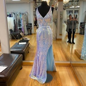 Fully sequined light blue prom gown with high slit and low back.